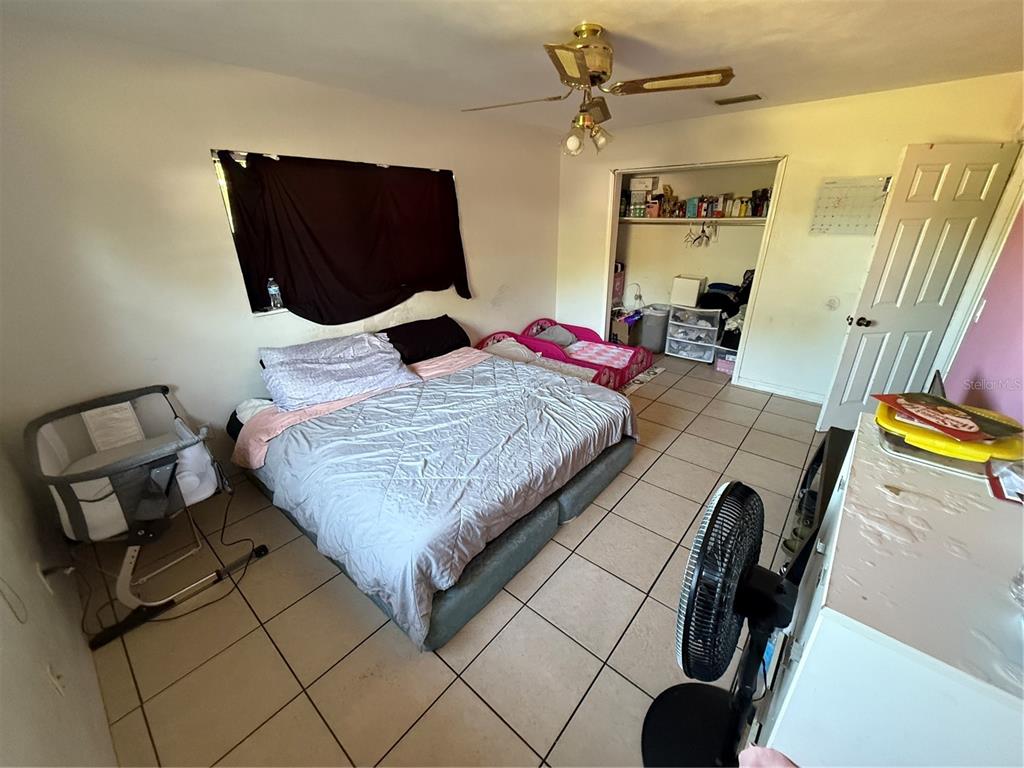 460 West Pierce Street Lake Alfred, FL 33850 - Photo 23 of 41 a bedroom with a bed and wooden floor