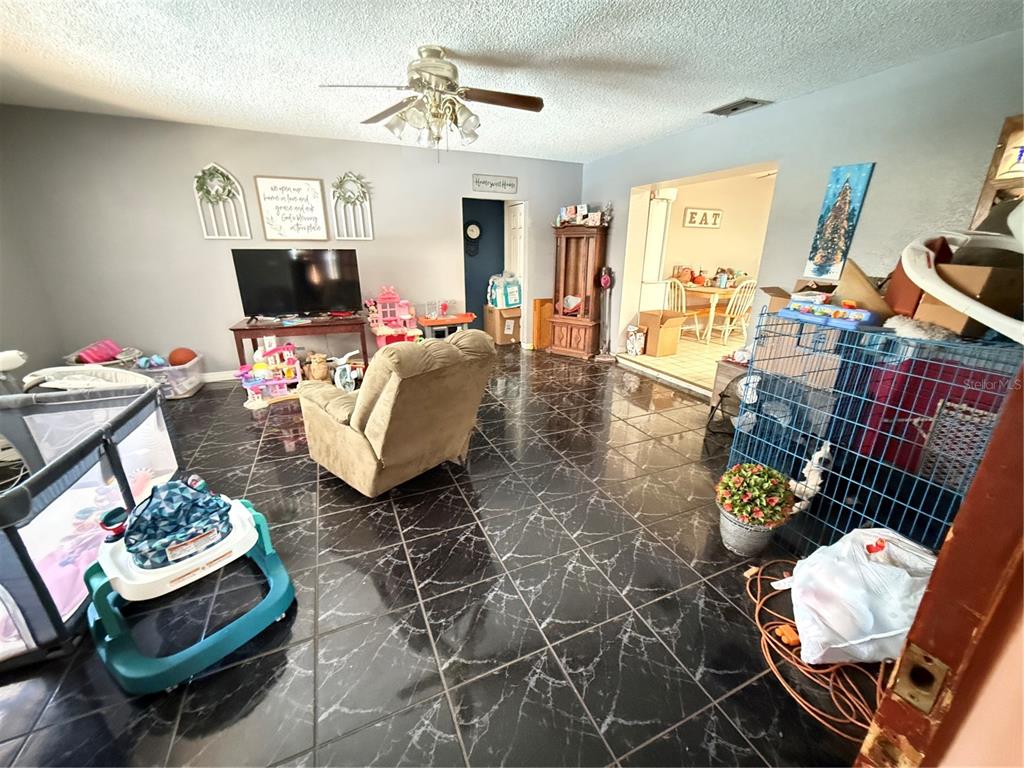 460 West Pierce Street Lake Alfred, FL 33850 - Photo 26 of 41 a living room with furniture and a flat screen tv
