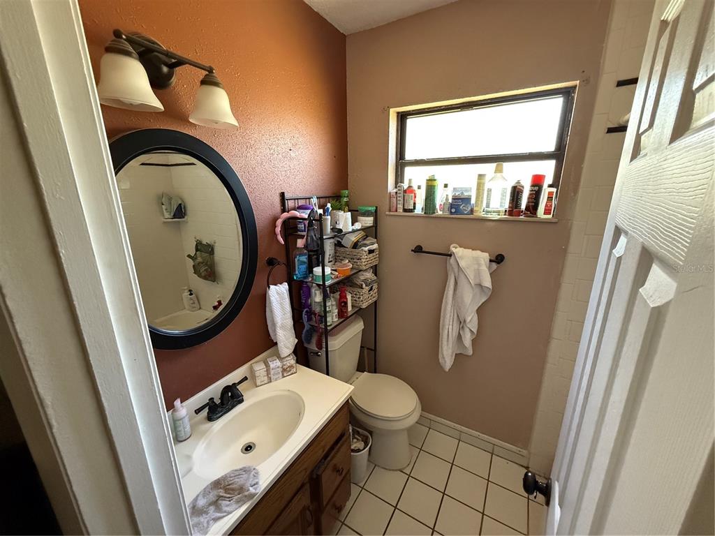 460 West Pierce Street Lake Alfred, FL 33850 - Photo 29 of 41 a bathroom with a toilet a sink and a mirror