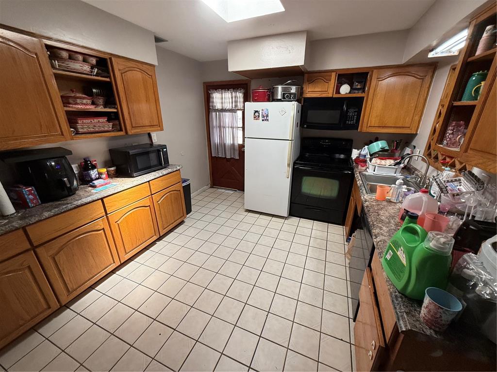 460 West Pierce Street Lake Alfred, FL 33850 - Photo 3 of 41 a kitchen with stainless steel appliances a refrigerator sink and cabinets