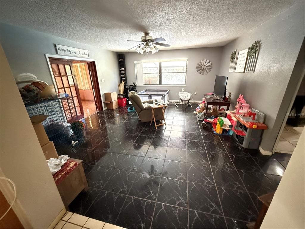 460 West Pierce Street Lake Alfred, FL 33850 - Photo 6 of 41 a living room with furniture and a chandelier