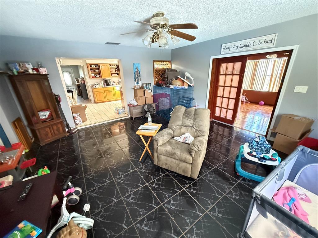 460 West Pierce Street Lake Alfred, FL 33850 - Photo 7 of 41 a living room with furniture a rug and a flat screen tv