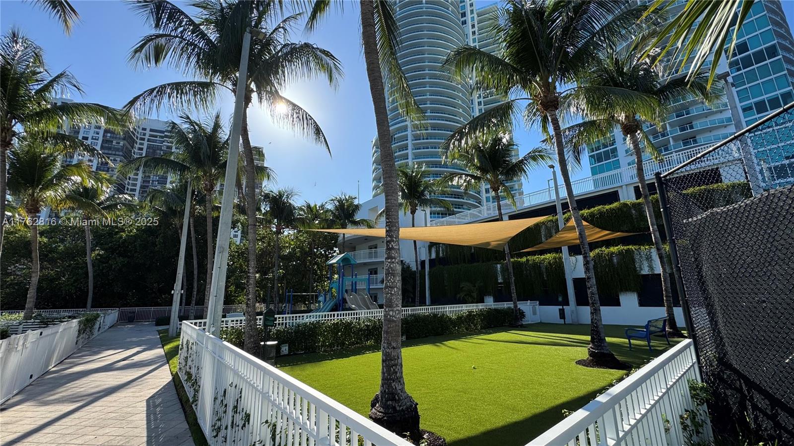 2101 Brickell Avenue, Unit 1012 Miami, FL 33129 - Photo 13 of 40 a view of a swimming pool with a patio and palm trees