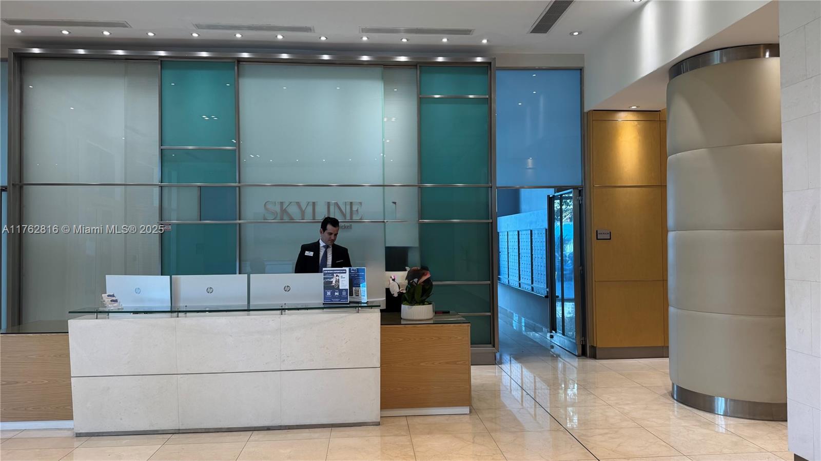 2101 Brickell Avenue, Unit 1012 Miami, FL 33129 - Photo 2 of 40 a bathroom with a sink a large mirror and a glass door shower