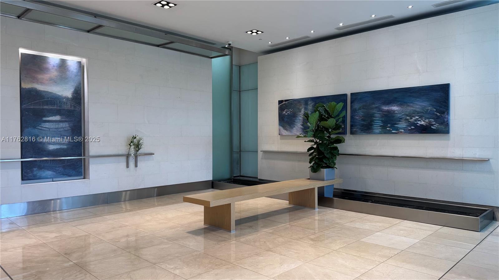 2101 Brickell Avenue, Unit 1012 Miami, FL 33129 - Photo 3 of 40 a living room with furniture and a flat screen tv