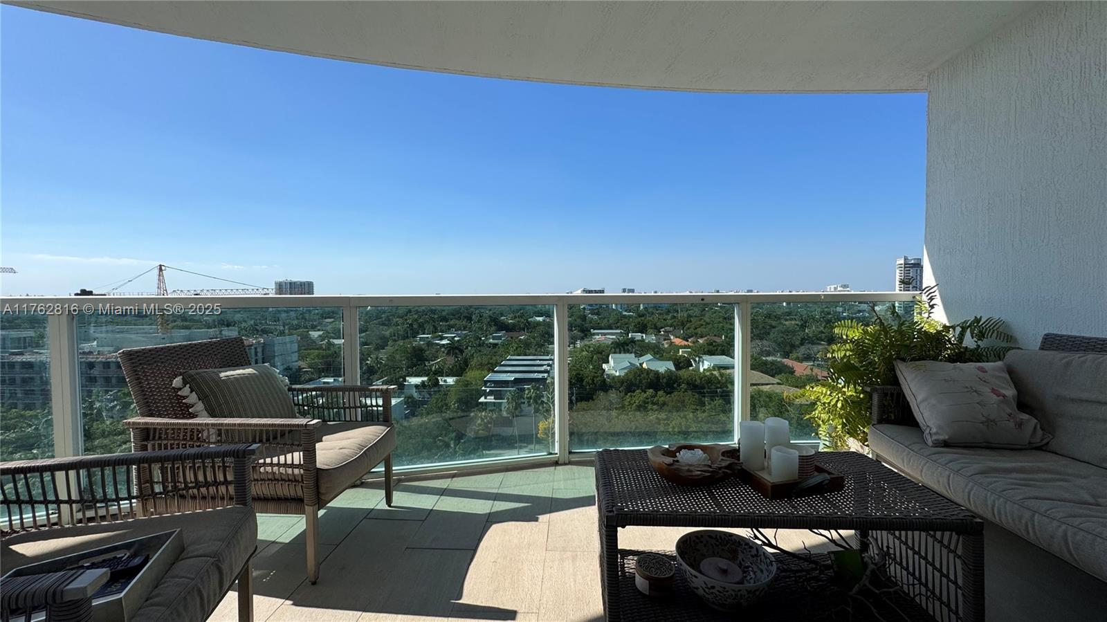 2101 Brickell Avenue, Unit 1012 Miami, FL 33129 - Photo 35 of 40 a view of a patio with couches potted plants and city view