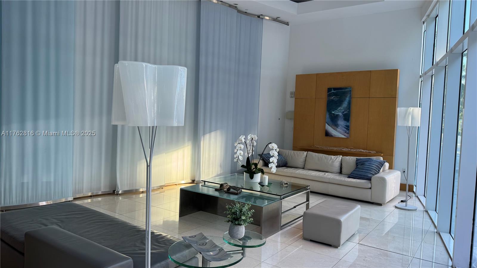 2101 Brickell Avenue, Unit 1012 Miami, FL 33129 - Photo 5 of 40 a living room with furniture and a potted plant