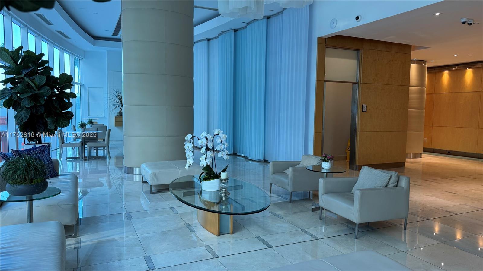 2101 Brickell Avenue, Unit 1012 Miami, FL 33129 - Photo 6 of 40 a living room with furniture and flowers