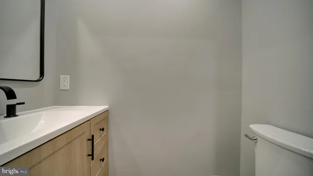 a view of staircase with white walls and a window