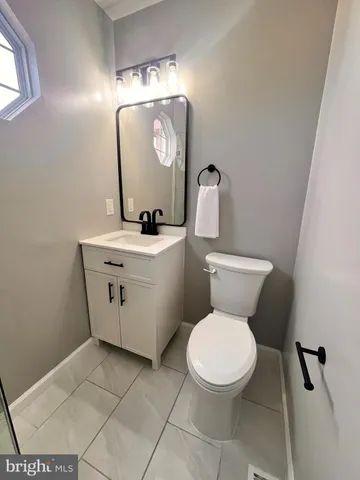 a white toilet sitting next to a bathroom sink