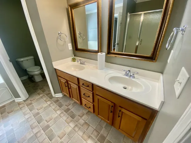 a bathroom with a double vanity sink and a mirror