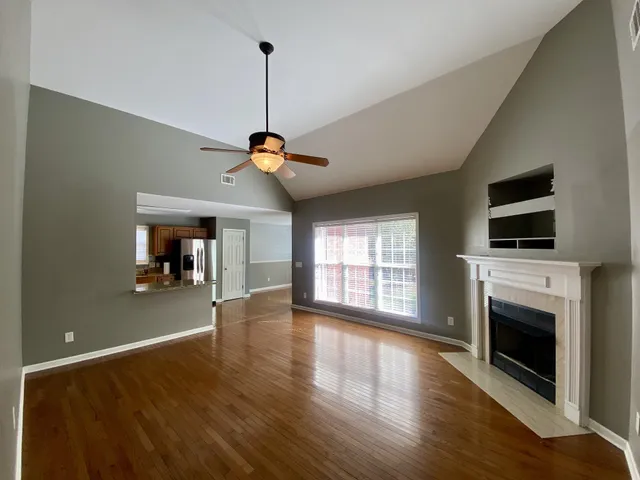 a view of a kitchen with a stove a kitchen island with wooden floor
