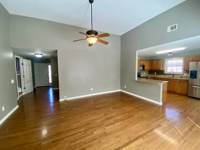 a kitchen with stainless steel appliances granite countertop a refrigerator a stove top oven a sink and dishwasher