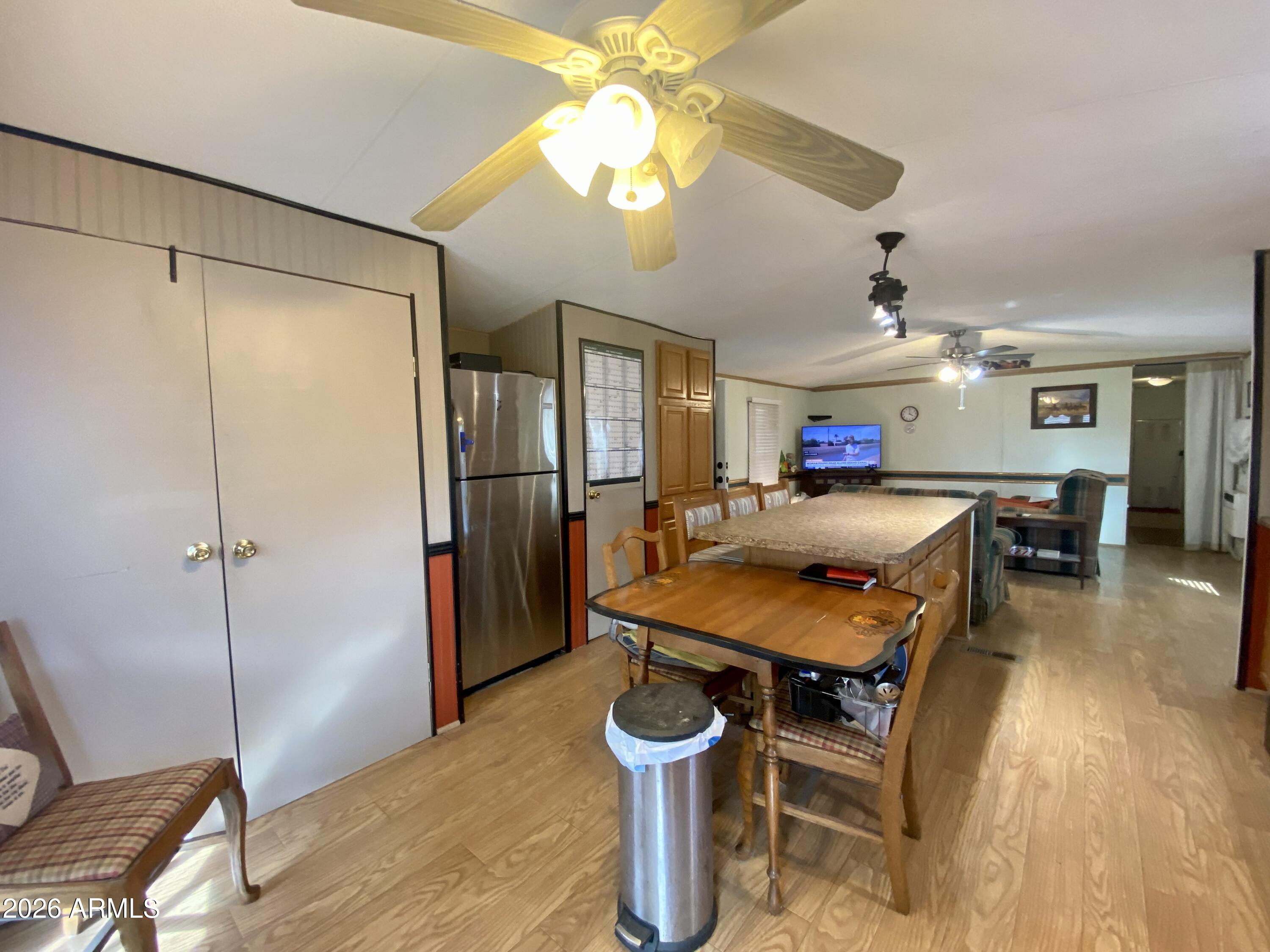 723 Finnie Flat Road, Unit 103 Camp Verde, AZ 86322 - Photo 11 of 41 a room with stainless steel appliances kitchen island granite countertop a table chairs and a refrigerator