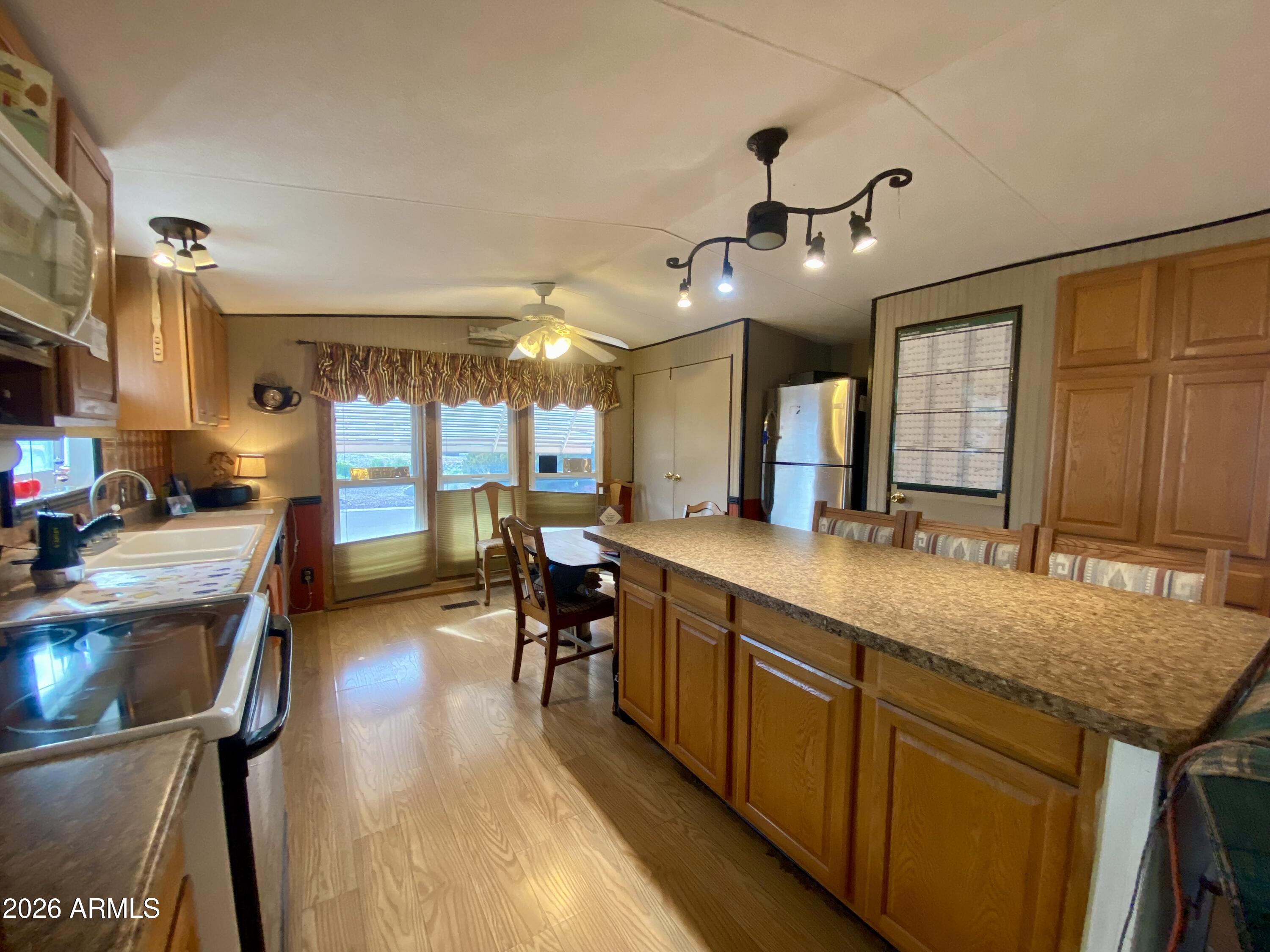 723 Finnie Flat Road, Unit 103 Camp Verde, AZ 86322 - Photo 15 of 41 a large kitchen with kitchen island a large island in it