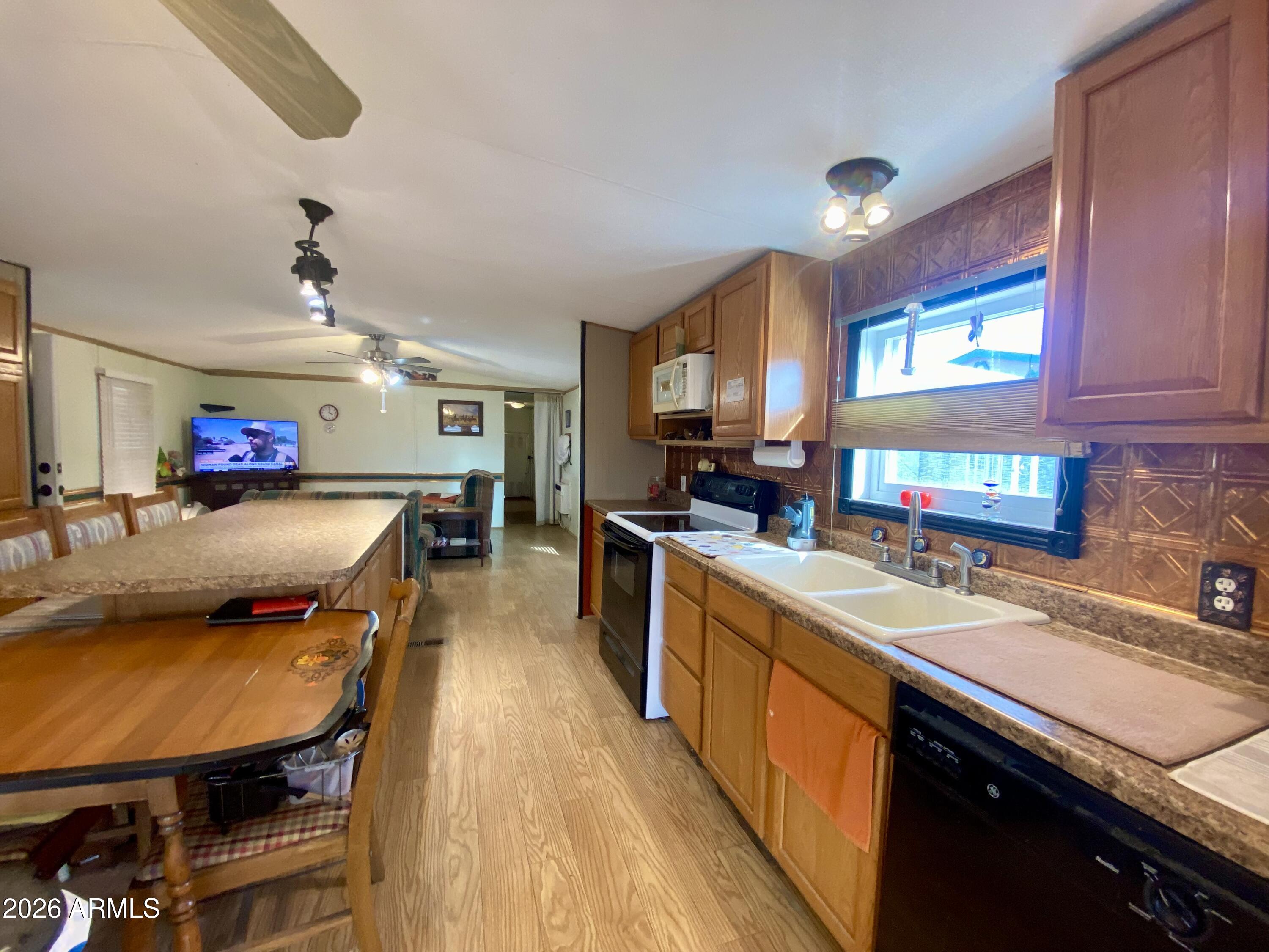723 Finnie Flat Road, Unit 103 Camp Verde, AZ 86322 - Photo 16 of 41 a kitchen with stainless steel appliances granite countertop sink stove top oven and cabinets