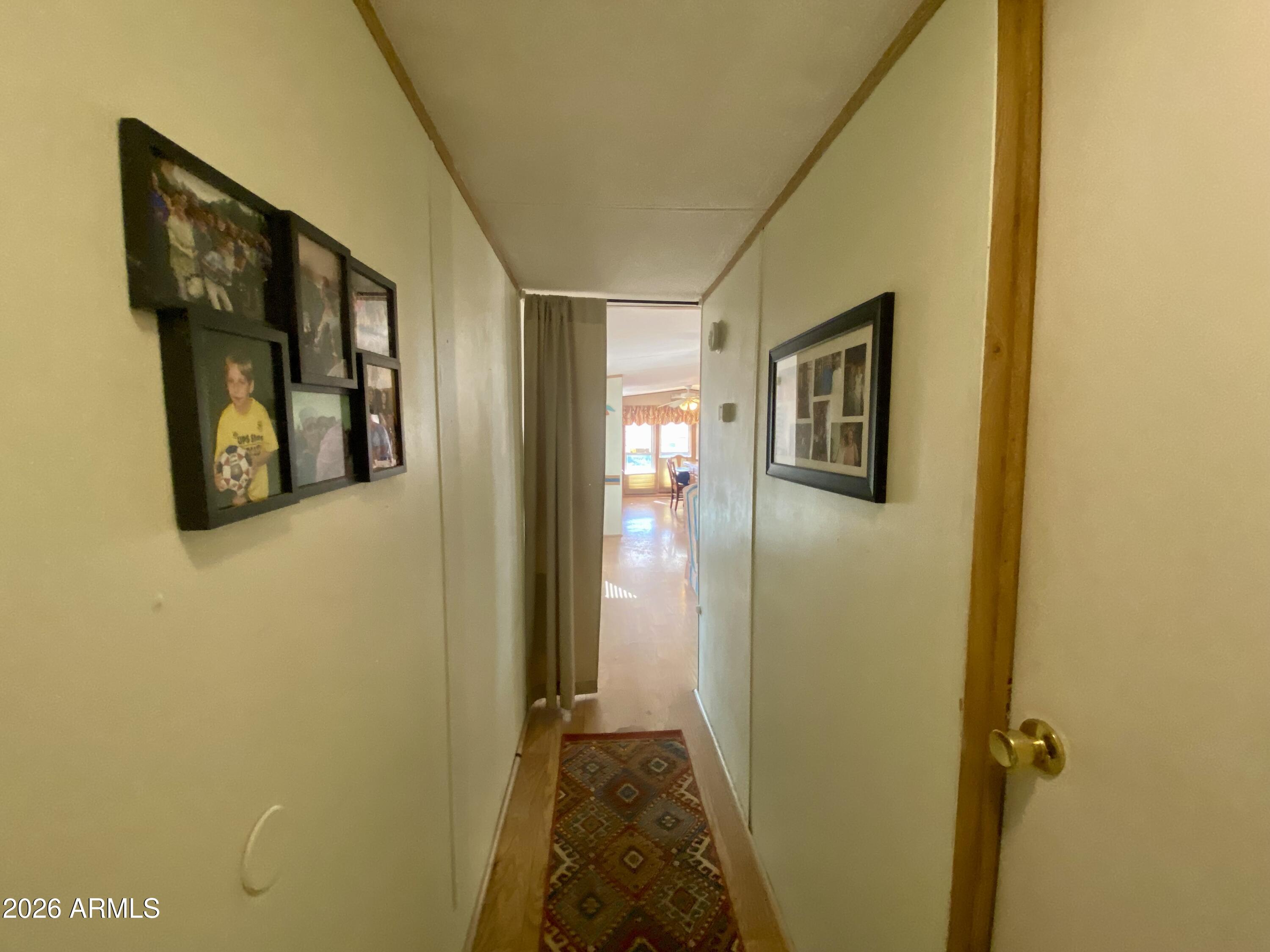 723 Finnie Flat Road, Unit 103 Camp Verde, AZ 86322 - Photo 19 of 41 a view of a hallway with wooden floor and closet