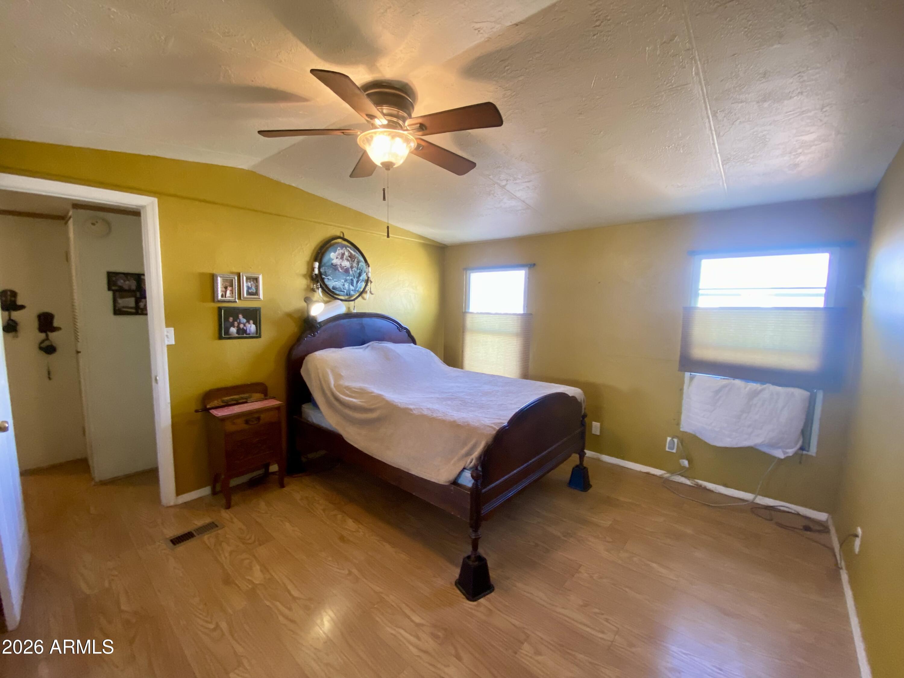723 Finnie Flat Road, Unit 103 Camp Verde, AZ 86322 - Photo 25 of 41 a bedroom with a bed and a chandelier