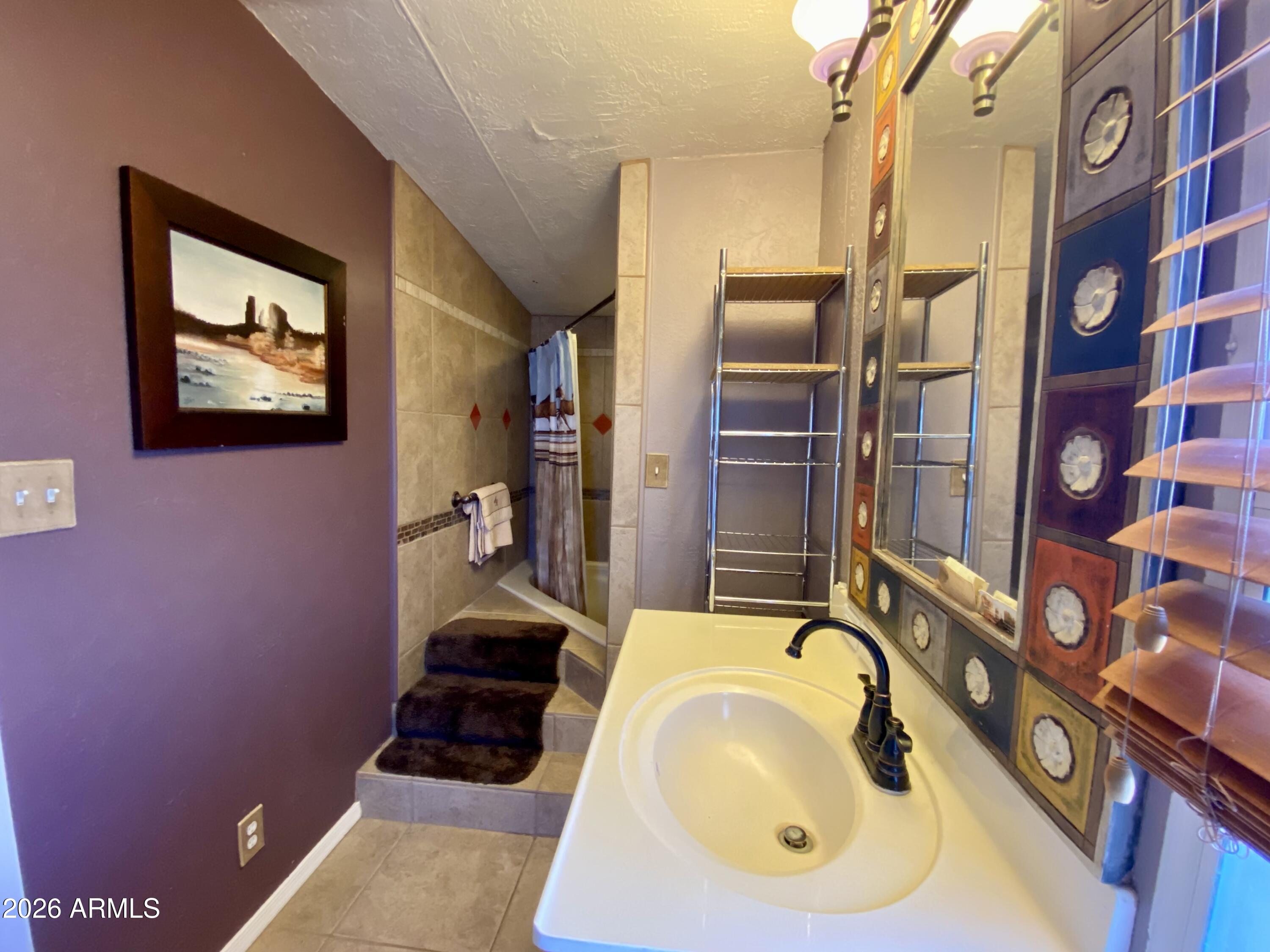 723 Finnie Flat Road, Unit 103 Camp Verde, AZ 86322 - Photo 28 of 41 a bathroom with a sink and a mirror