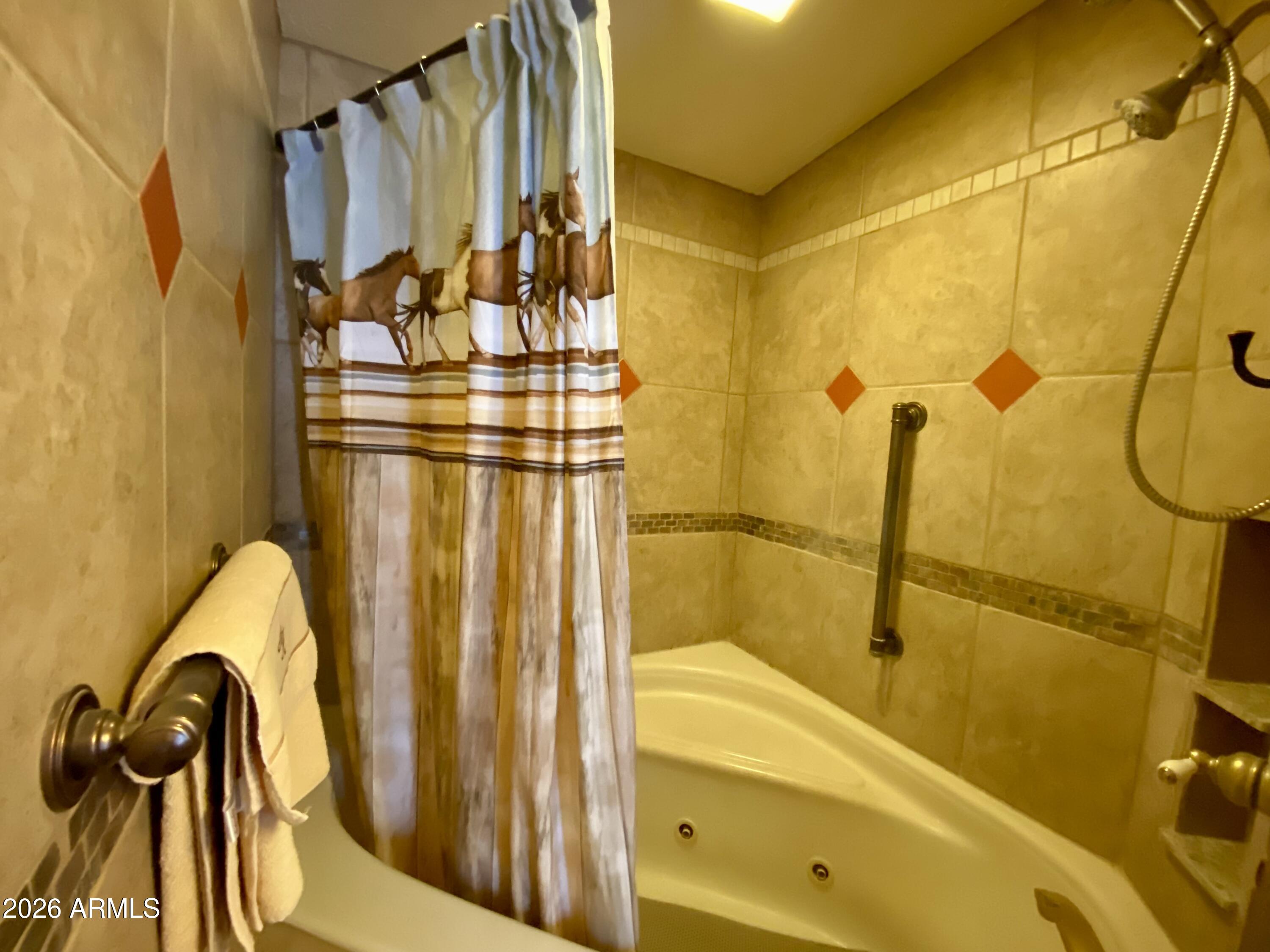 723 Finnie Flat Road, Unit 103 Camp Verde, AZ 86322 - Photo 30 of 41 a view of a bathroom with tub and shower