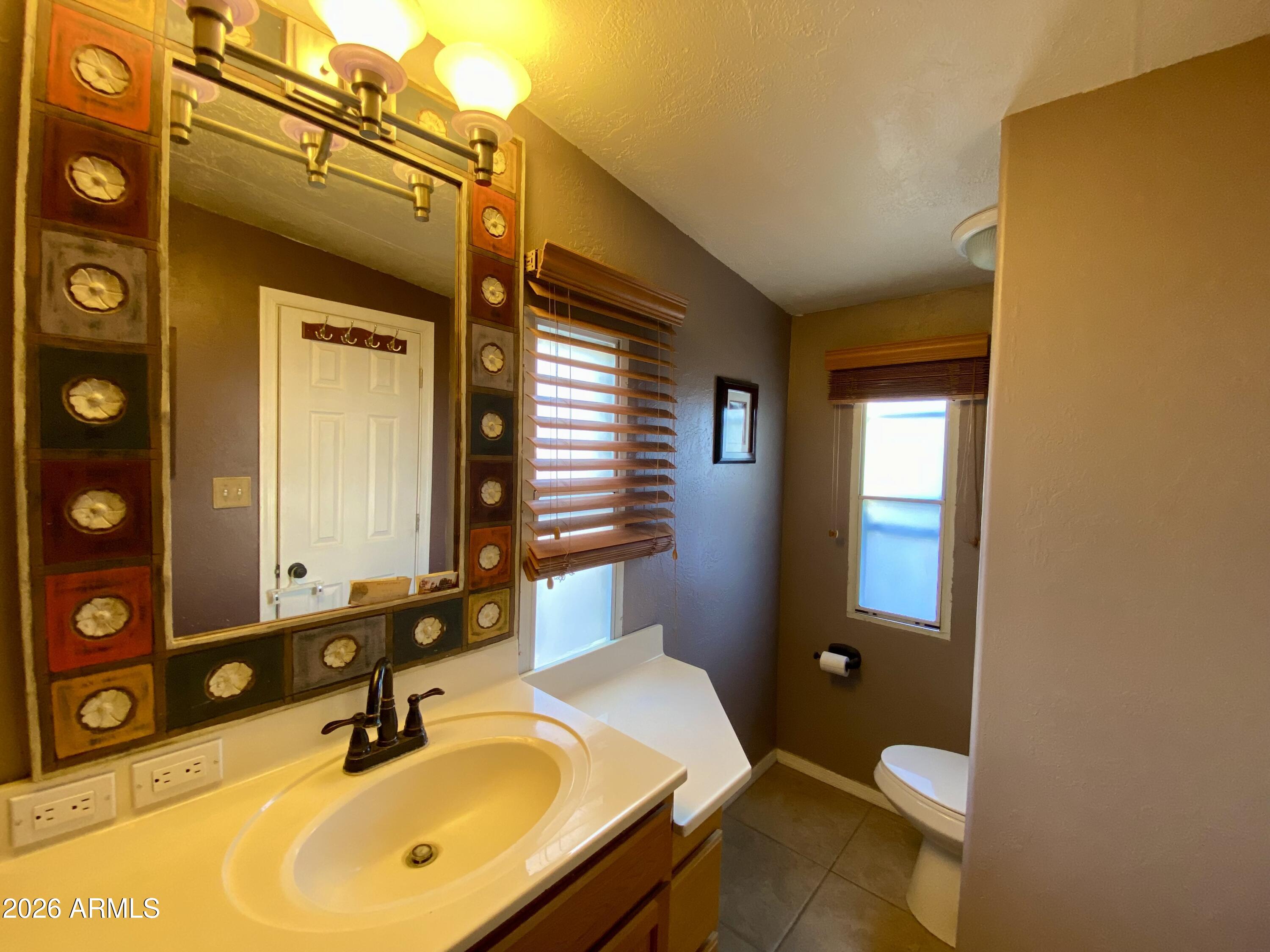 723 Finnie Flat Road, Unit 103 Camp Verde, AZ 86322 - Photo 31 of 41 a bathroom with a sink and a mirror