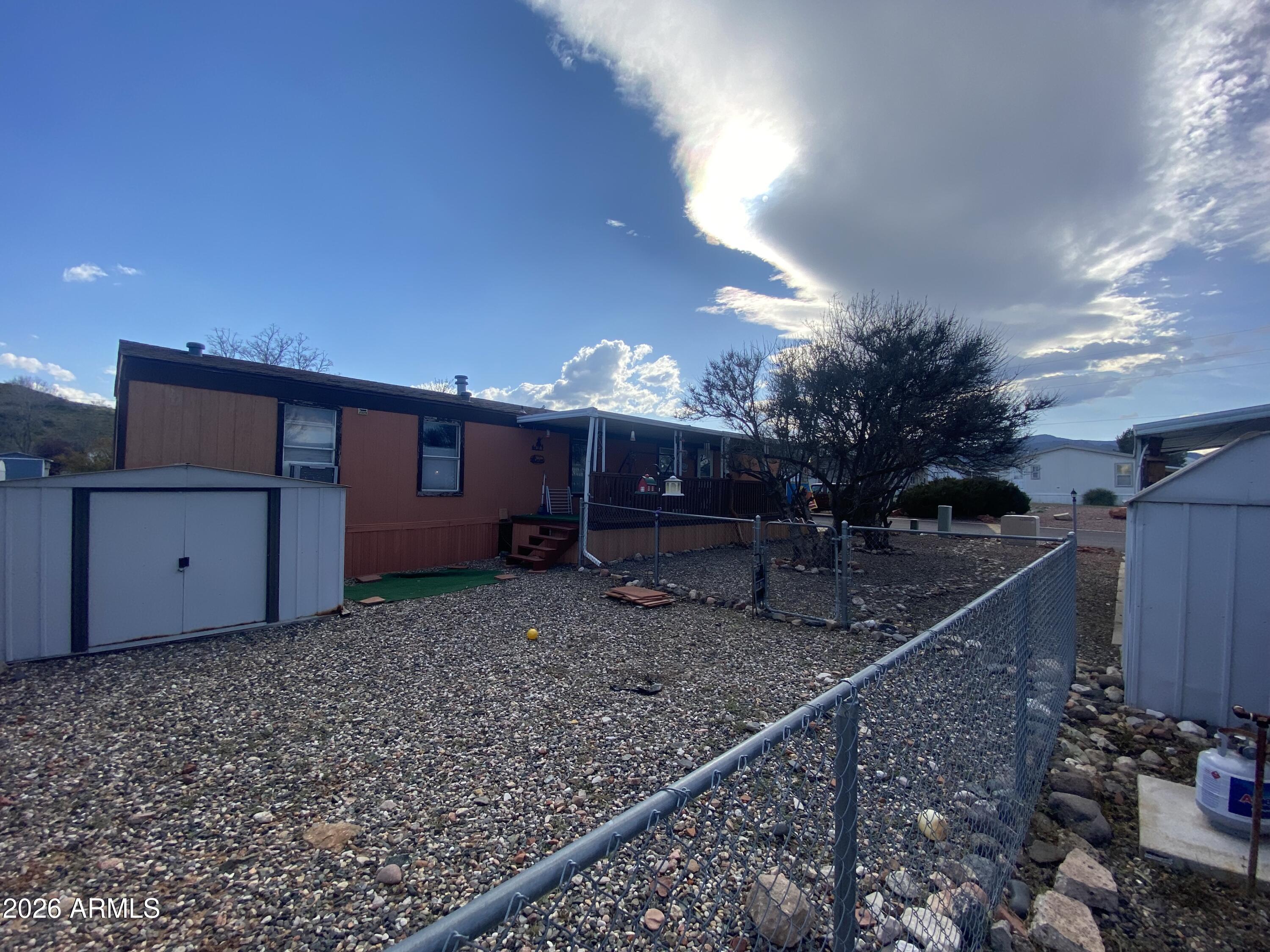 723 Finnie Flat Road, Unit 103 Camp Verde, AZ 86322 - Photo 37 of 41 a view of a house with a yard