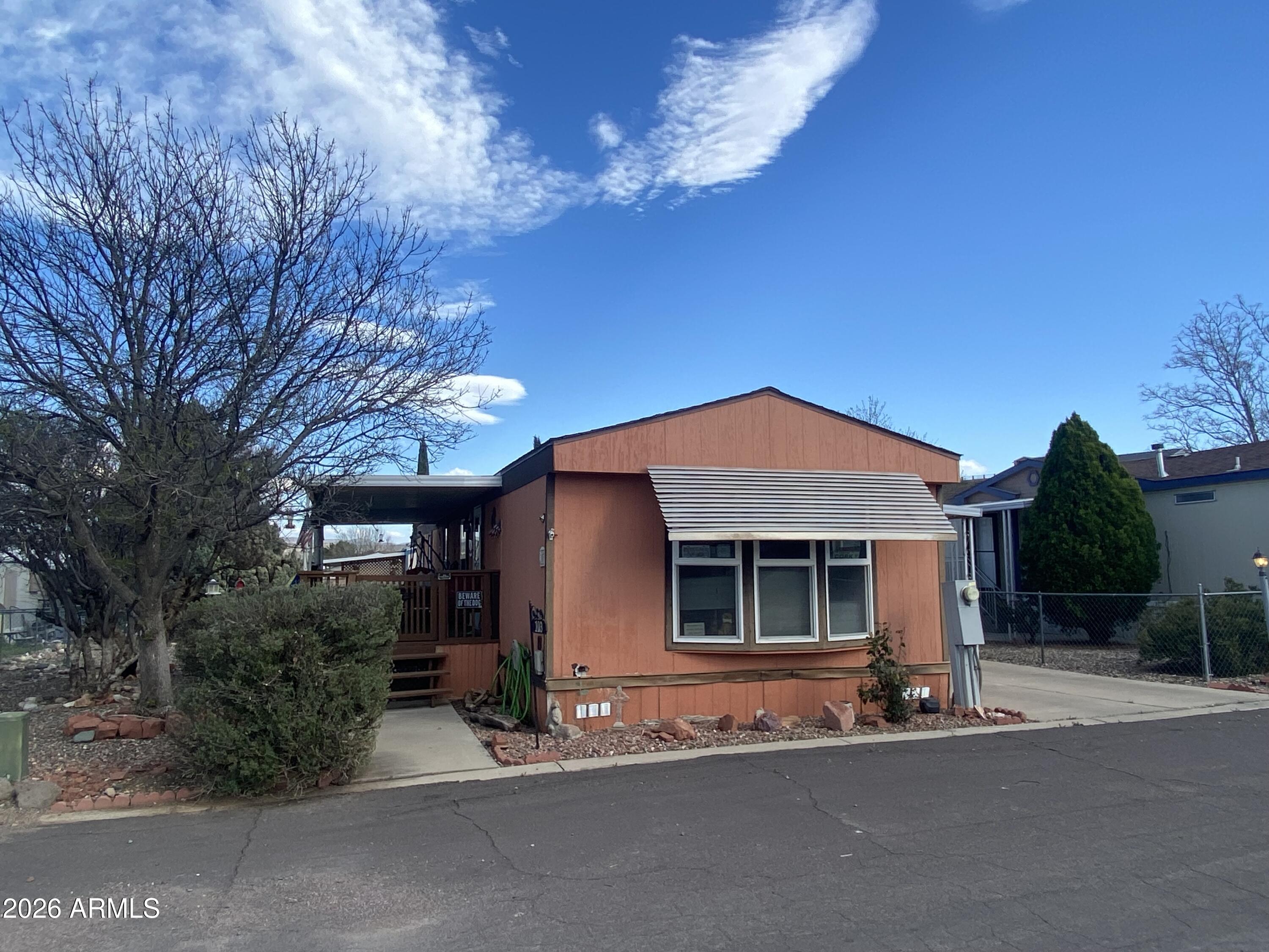 723 Finnie Flat Road, Unit 103 Camp Verde, AZ 86322 - Photo 38 of 41 a front view of a house with a yard