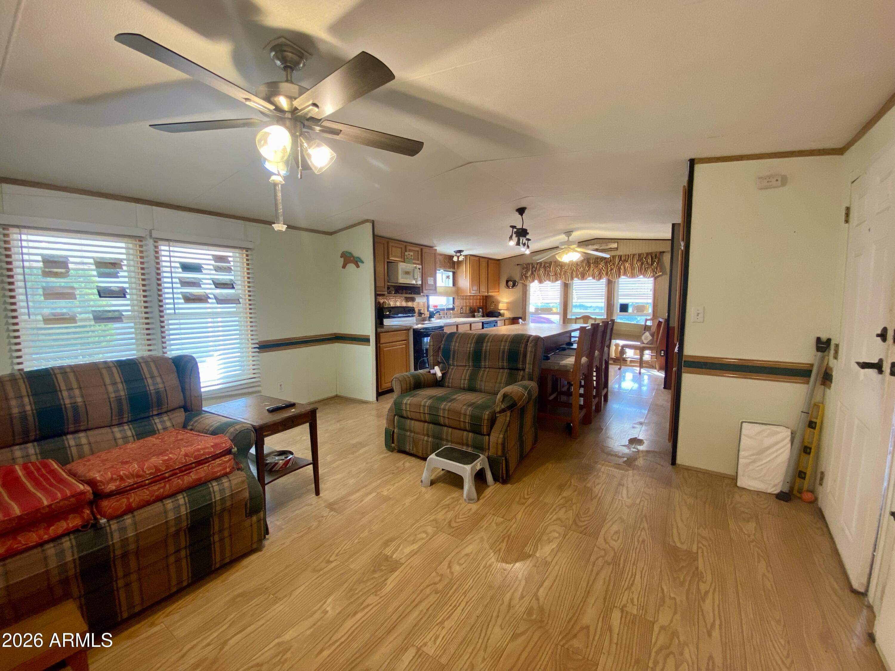 723 Finnie Flat Road, Unit 103 Camp Verde, AZ 86322 - Photo 6 of 41 a living room with furniture and a chandelier