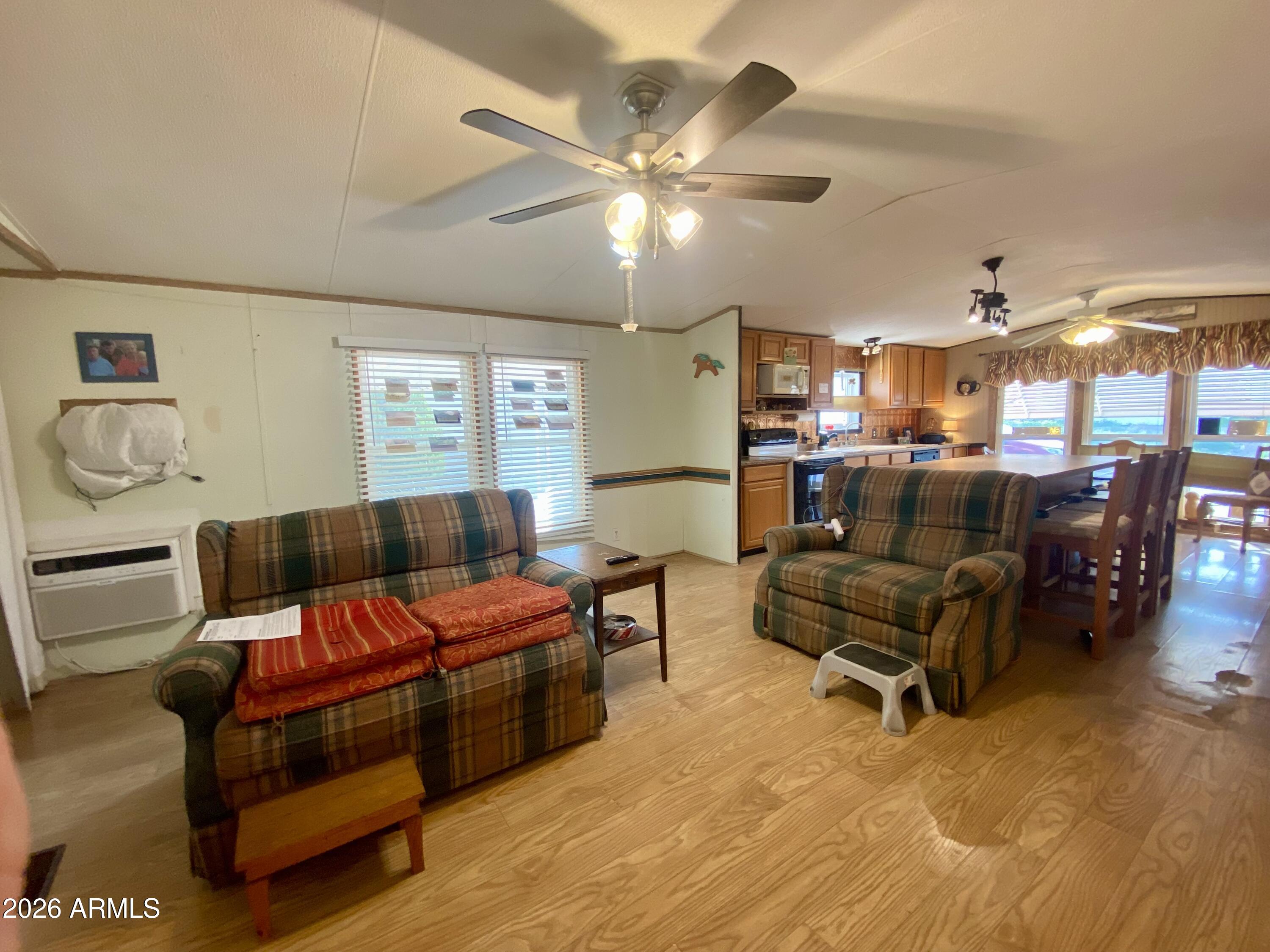 723 Finnie Flat Road, Unit 103 Camp Verde, AZ 86322 - Photo 7 of 41 a living room with furniture and a chandelier