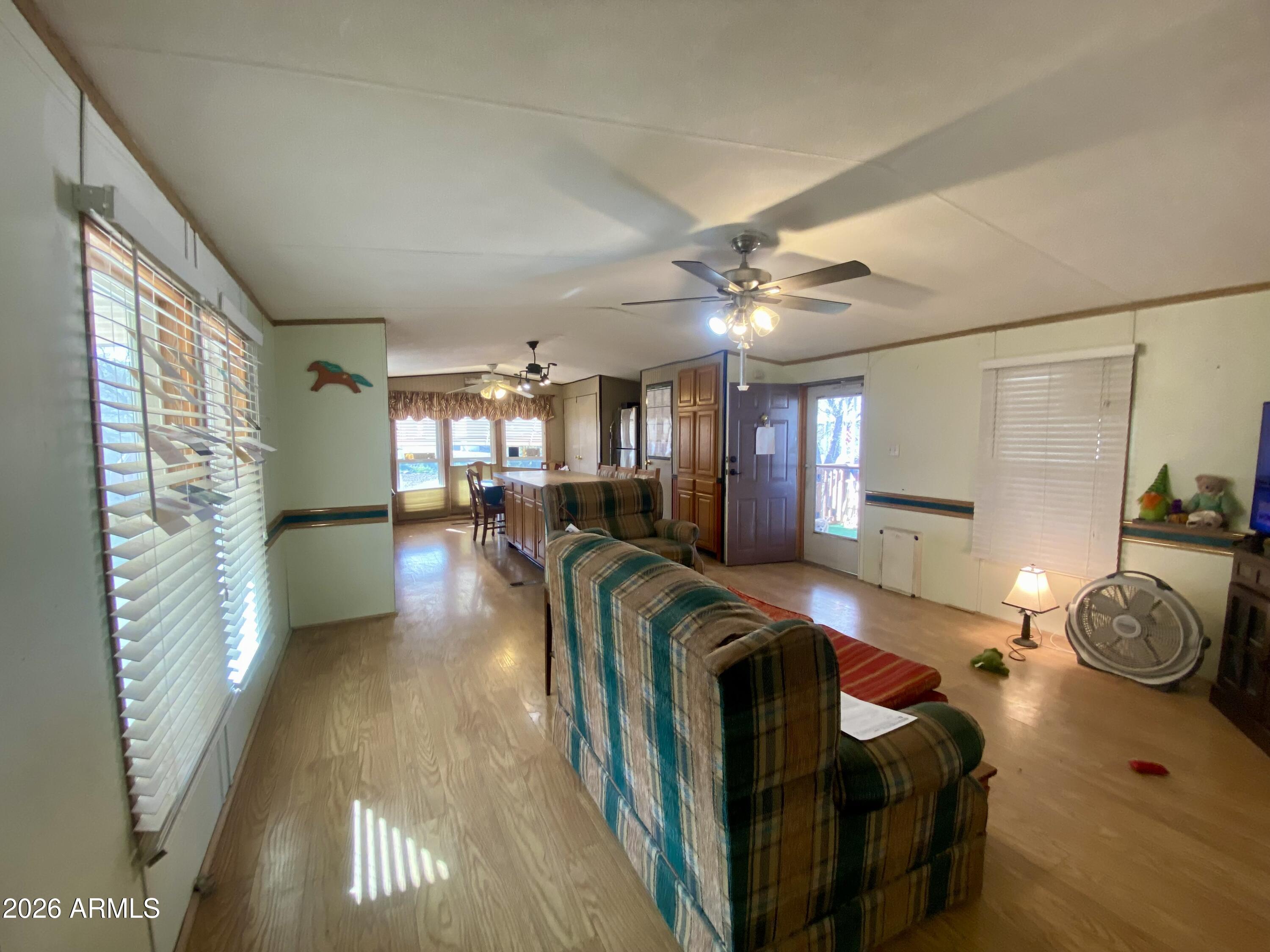 723 Finnie Flat Road, Unit 103 Camp Verde, AZ 86322 - Photo 8 of 41 a living room with furniture and a chandelier