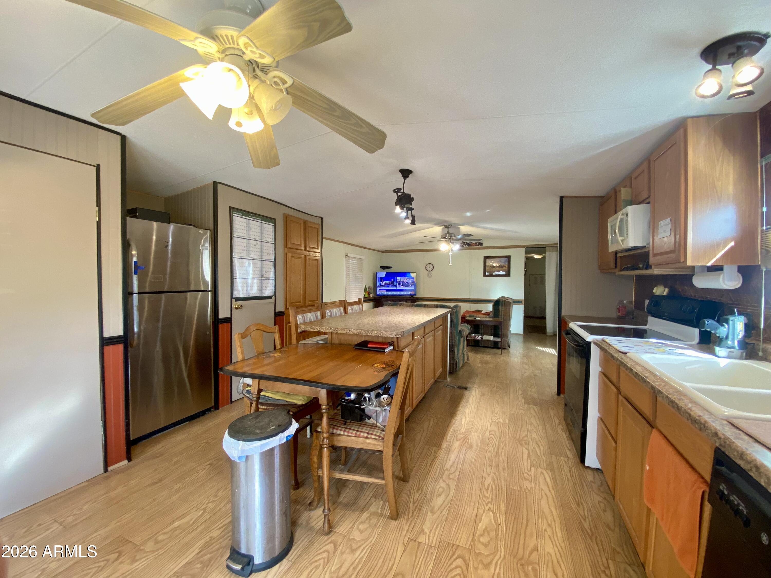 723 Finnie Flat Road, Unit 103 Camp Verde, AZ 86322 - Photo 10 of 41 a large kitchen with a table and chairs