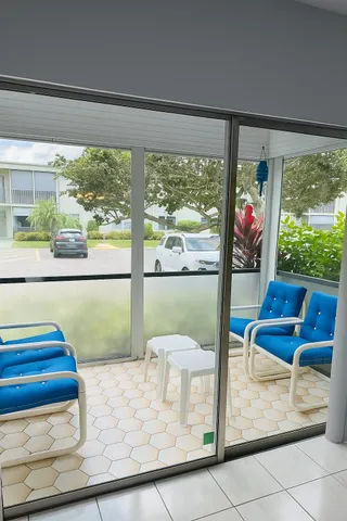 a view of a living room and floor to ceiling window