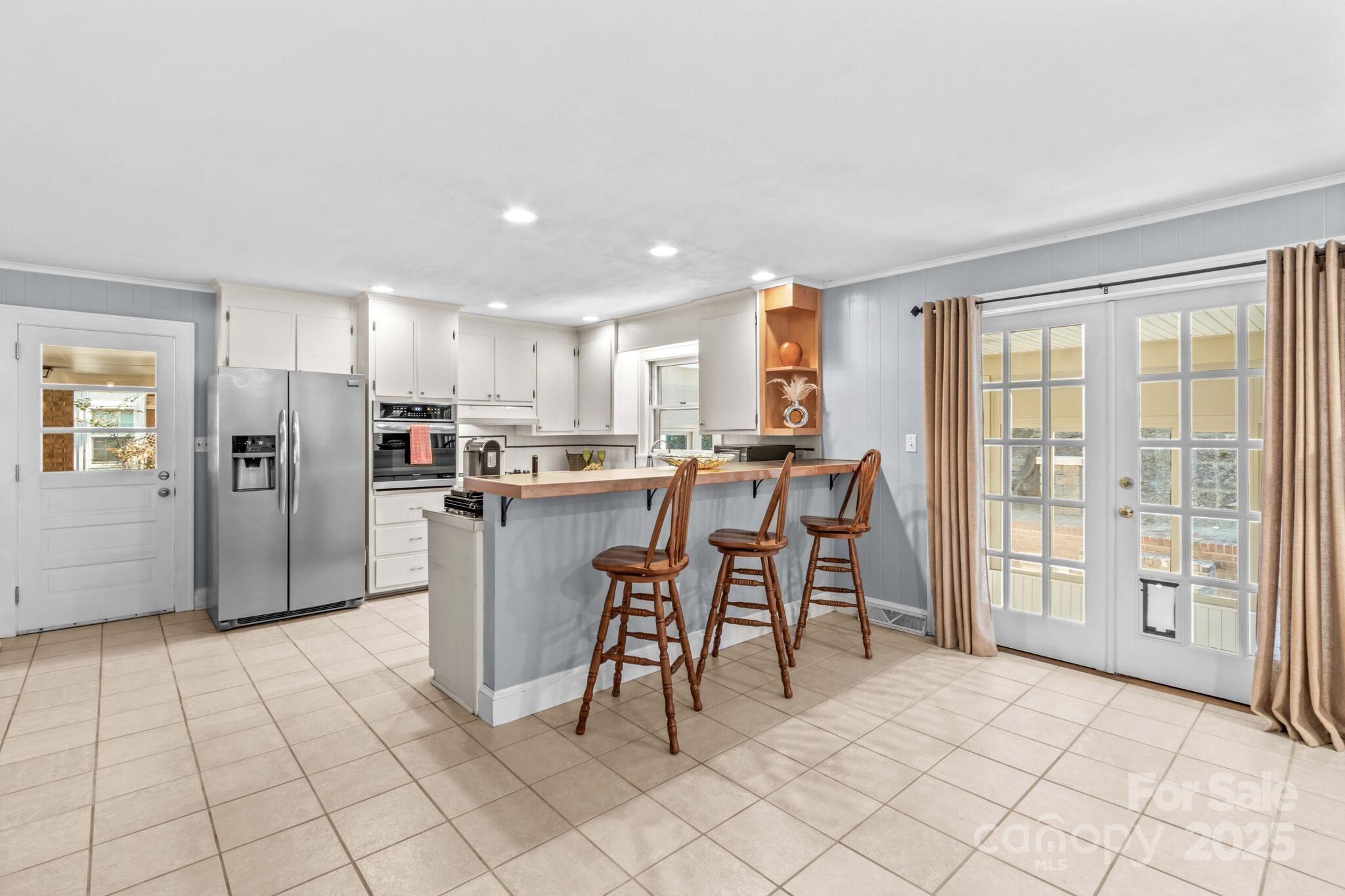 1231 Maxwell Street Salisbury, NC 28144 - Photo 13 of 42 a kitchen with stainless steel appliances kitchen island granite countertop a refrigerator and cabinets