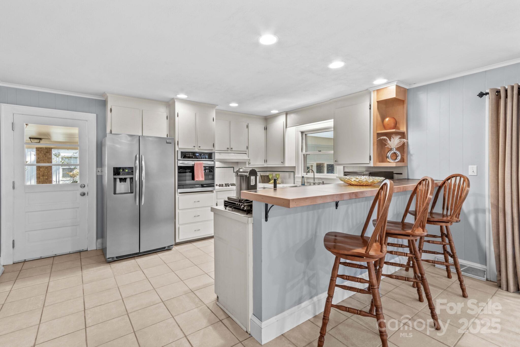 1231 Maxwell Street Salisbury, NC 28144 - Photo 14 of 42 a kitchen with a refrigerator a microwave and cabinets