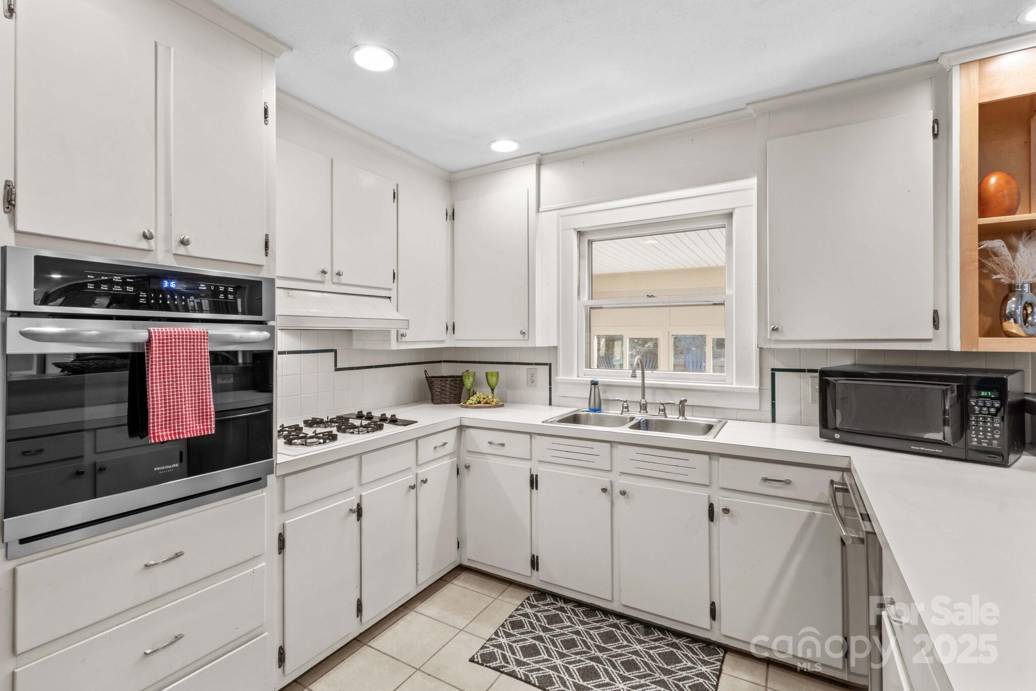 1231 Maxwell Street Salisbury, NC 28144 - Photo 16 of 42 a kitchen with cabinets appliances a sink and a window