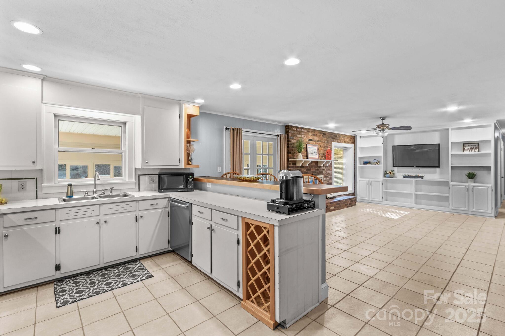 1231 Maxwell Street Salisbury, NC 28144 - Photo 17 of 42 a kitchen with stainless steel appliances granite countertop a stove sink and cabinets