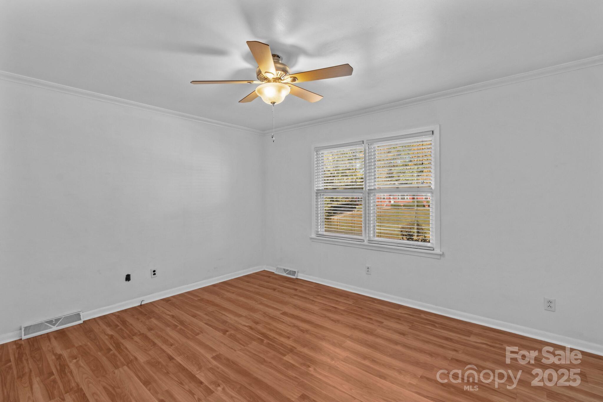 1231 Maxwell Street Salisbury, NC 28144 - Photo 18 of 42 a view of an empty room with wooden floor and a window