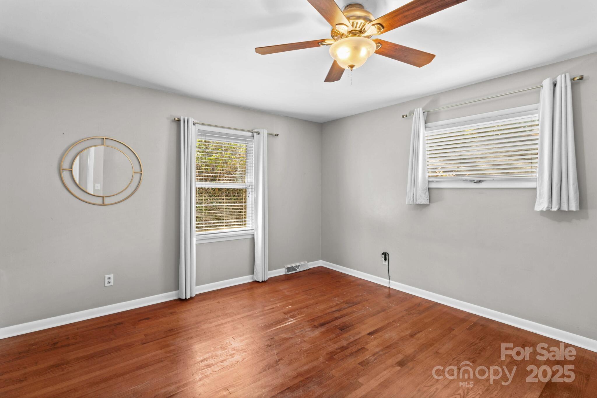 1231 Maxwell Street Salisbury, NC 28144 - Photo 21 of 42 a view of empty room with wooden floor and fan