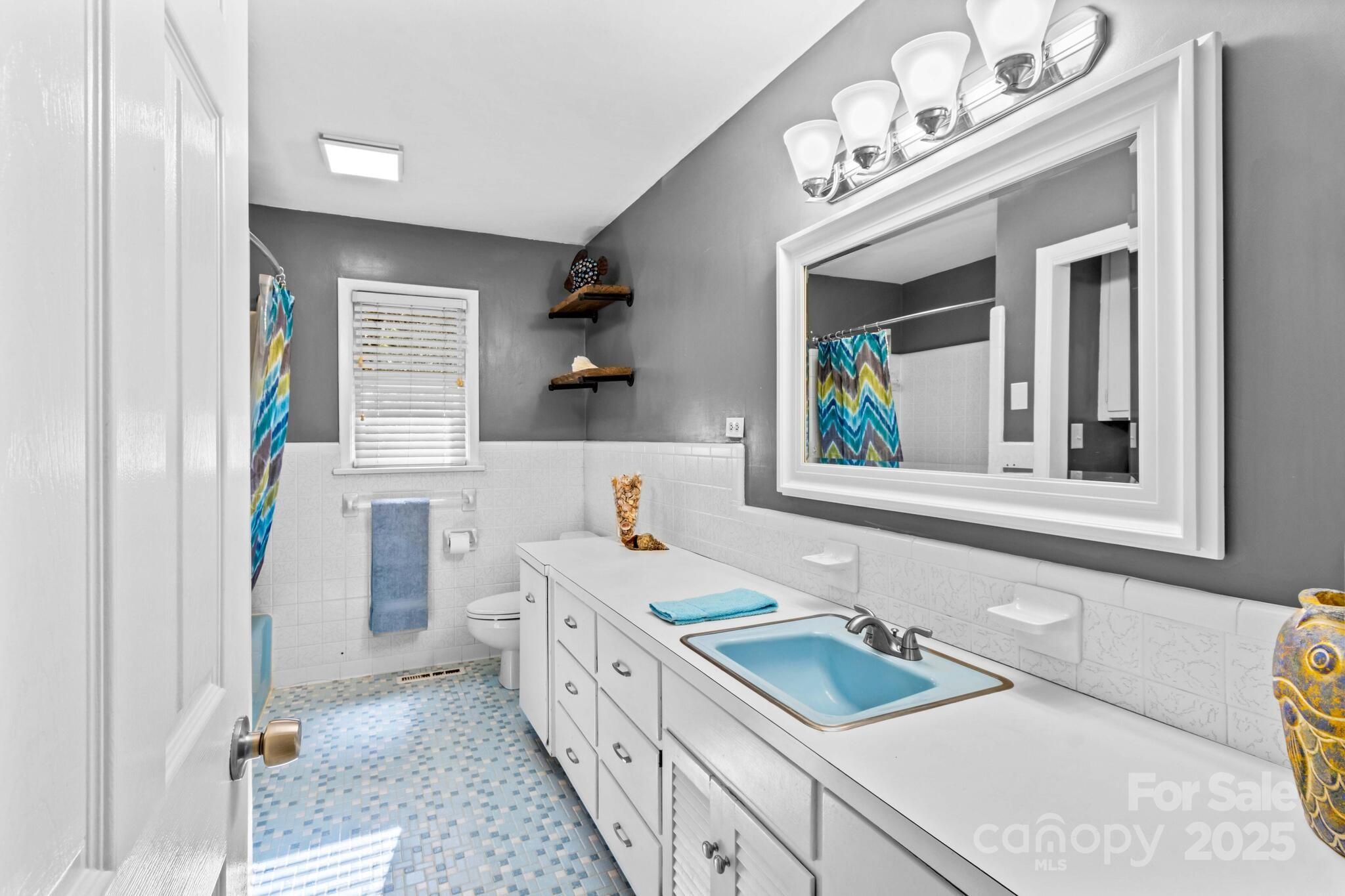 1231 Maxwell Street Salisbury, NC 28144 - Photo 22 of 42 a bathroom with a sink vanity granite tub and a mirror