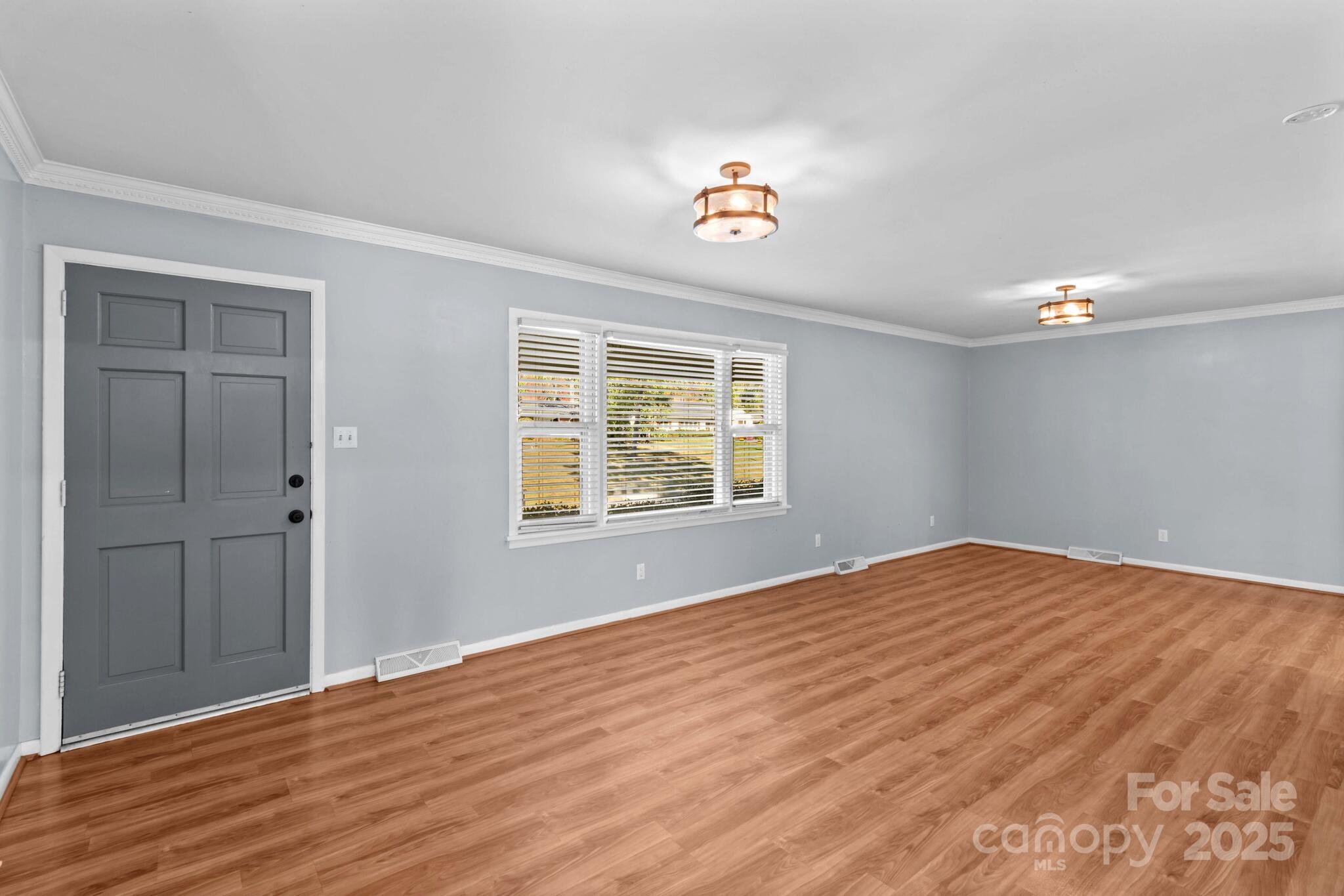 1231 Maxwell Street Salisbury, NC 28144 - Photo 6 of 42 a view of an empty room with wooden floor and a window
