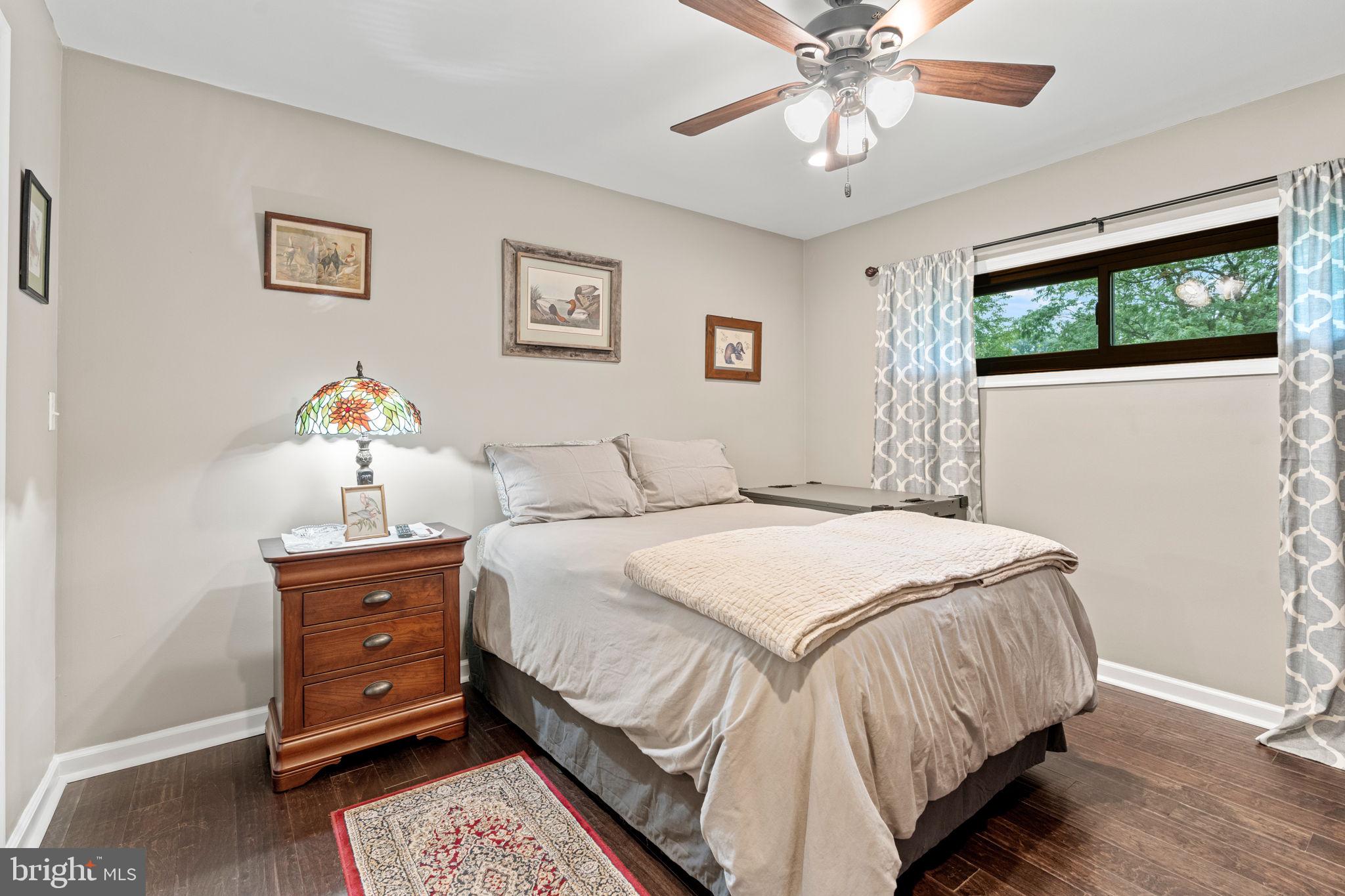 205 East Glenn Road Hershey, PA 17033 - Photo 28 of 52 a bedroom with a bed and a chandelier