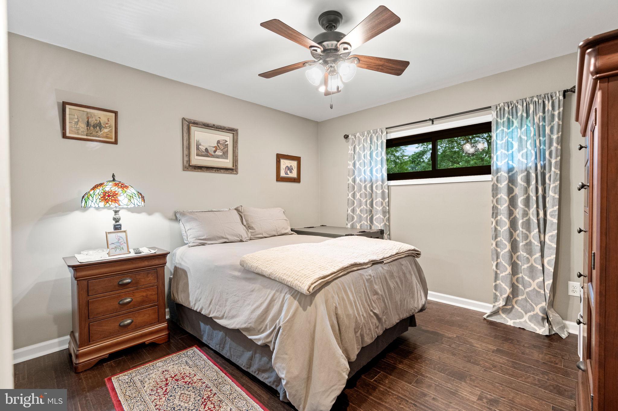205 East Glenn Road Hershey, PA 17033 - Photo 30 of 52 a bedroom with a bed and a chandelier