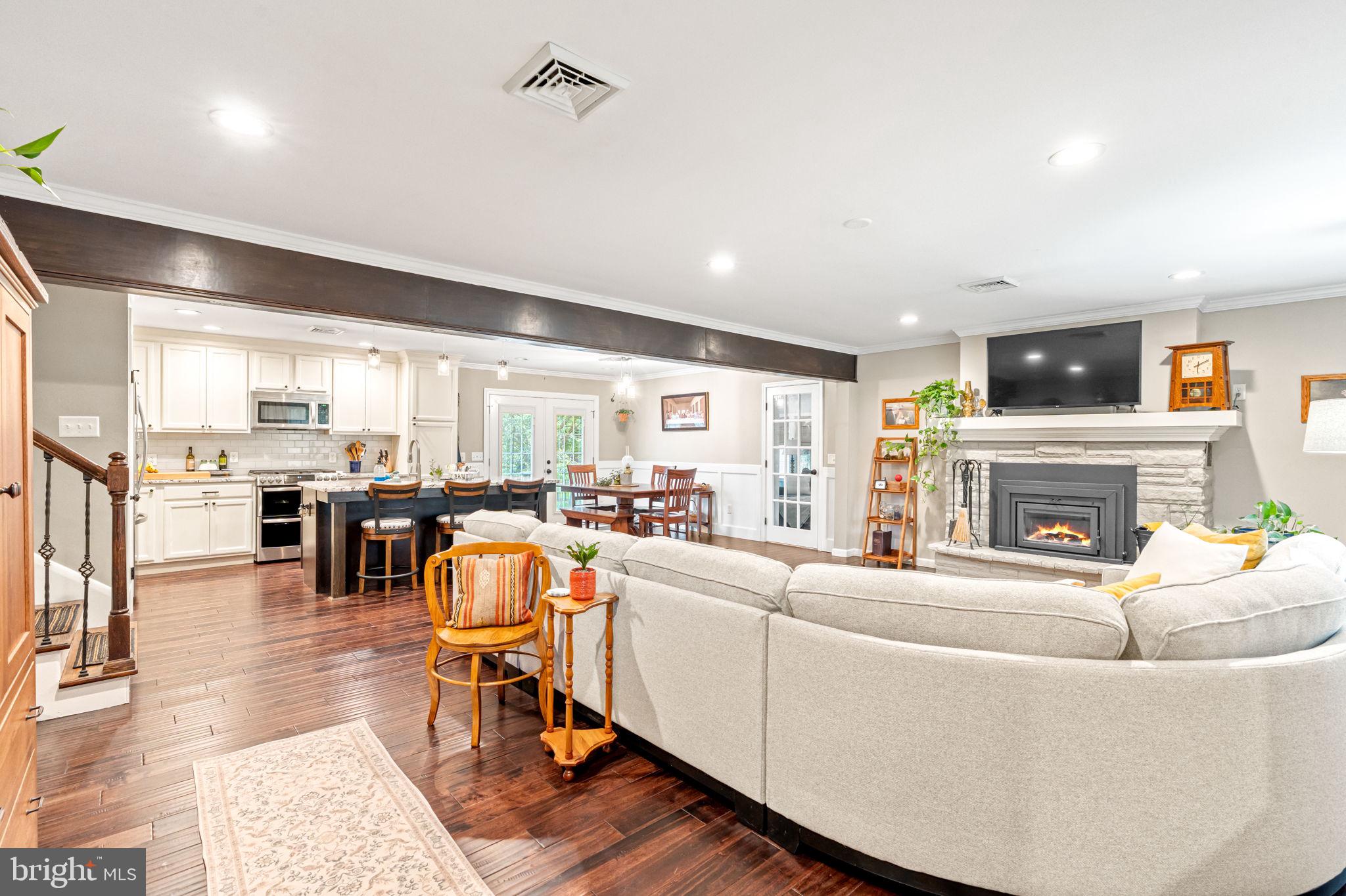 205 East Glenn Road Hershey, PA 17033 - Photo 5 of 52 a living room with furniture a fireplace and kitchen view
