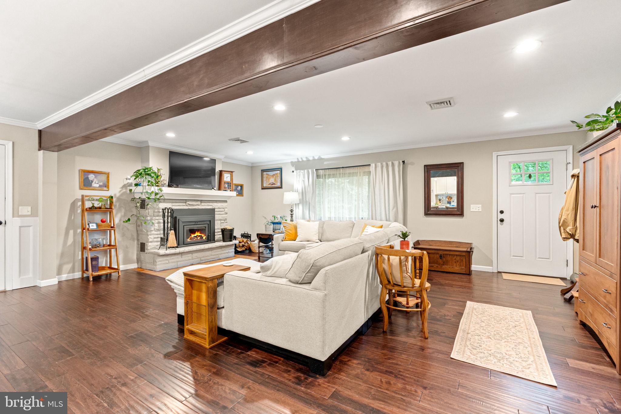 205 East Glenn Road Hershey, PA 17033 - Photo 7 of 52 a living room with furniture a fireplace and a flat screen tv