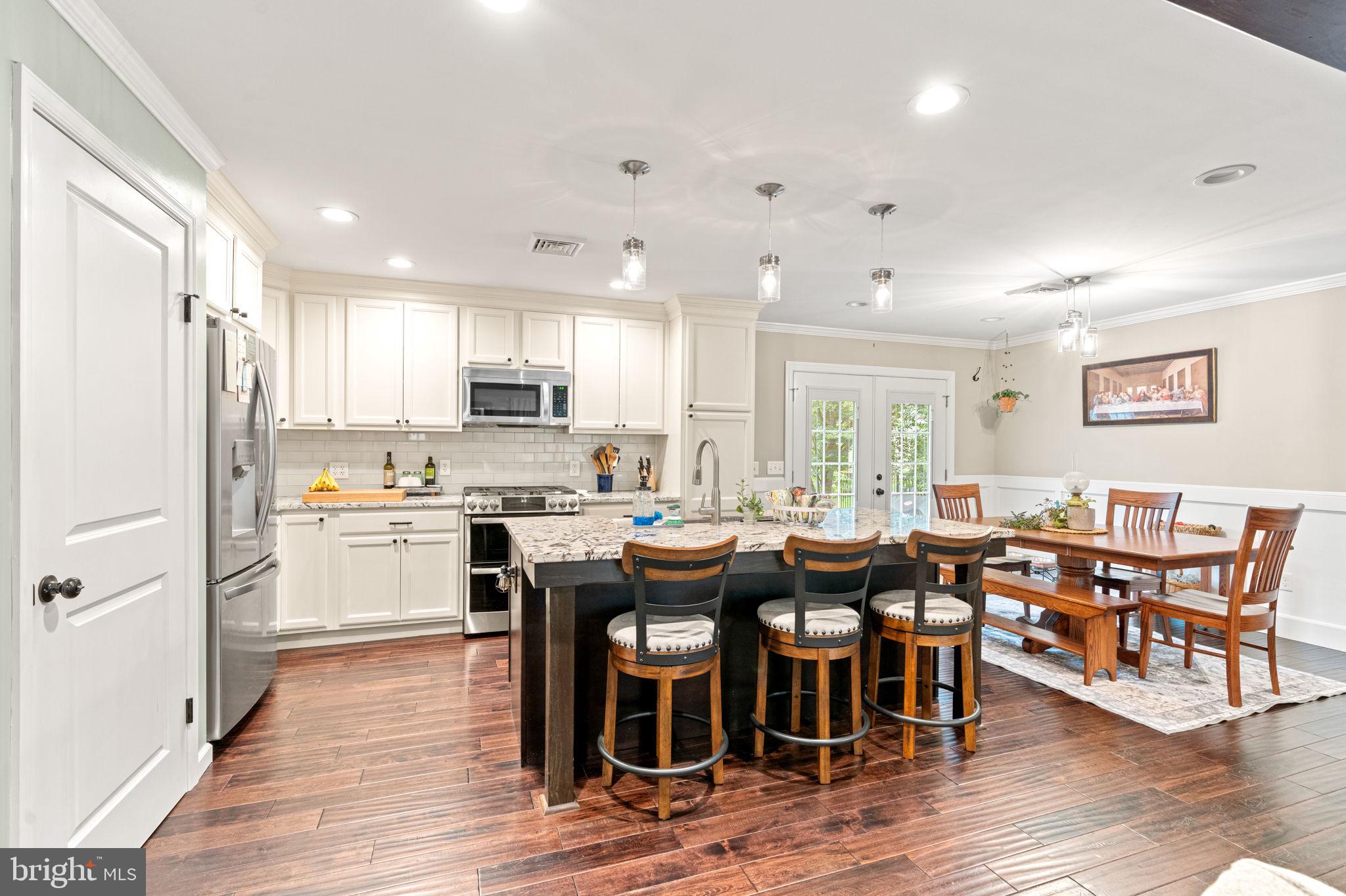 205 East Glenn Road Hershey, PA 17033 - Photo 9 of 52 a open dining room with stainless steel appliances kitchen island granite countertop a dining table chairs and granite counter tops