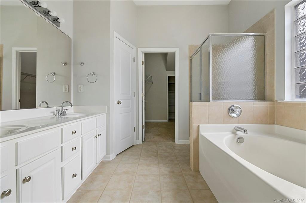 268 Sand Paver Way Fort Mill, SC 29708 - Photo 15 of 23 a spacious bathroom with a bathtub shower and double sink
