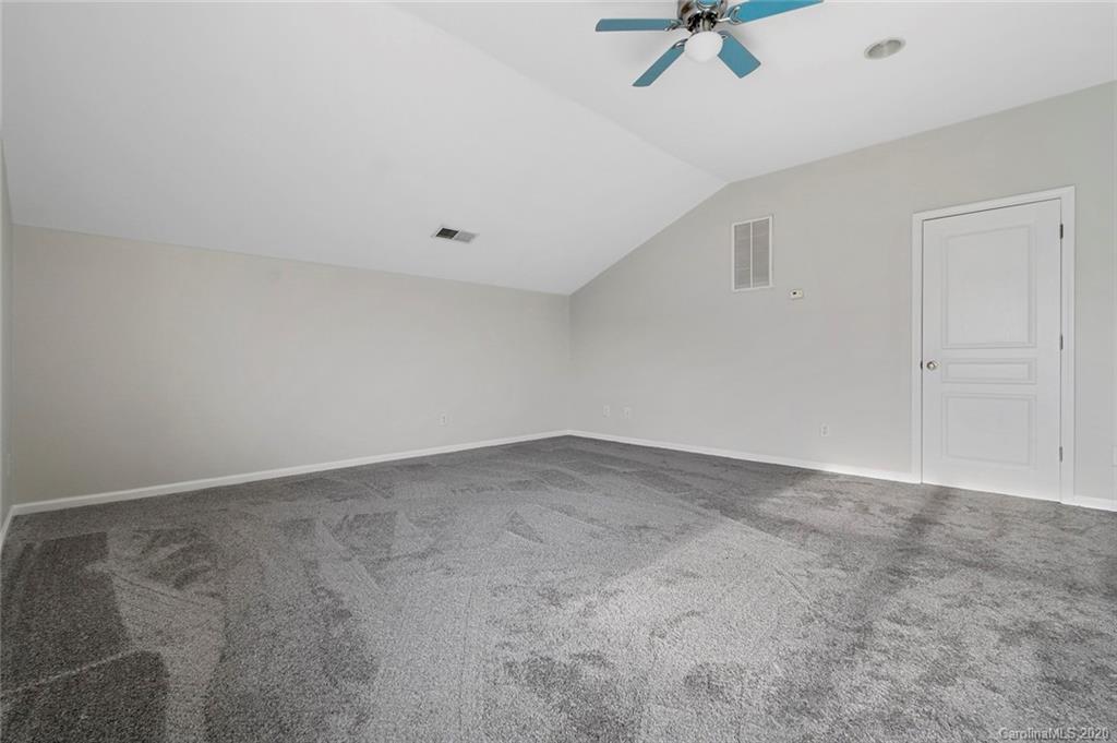 268 Sand Paver Way Fort Mill, SC 29708 - Photo 22 of 23 an empty room with a ceiling fan and carpet