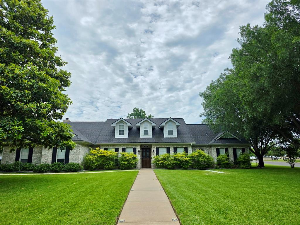 520 Red River Road Belton, TX 76513 - Photo 2 of 36 Brick exterior with dark shutters, a dark shingle roof, and three dormer windows