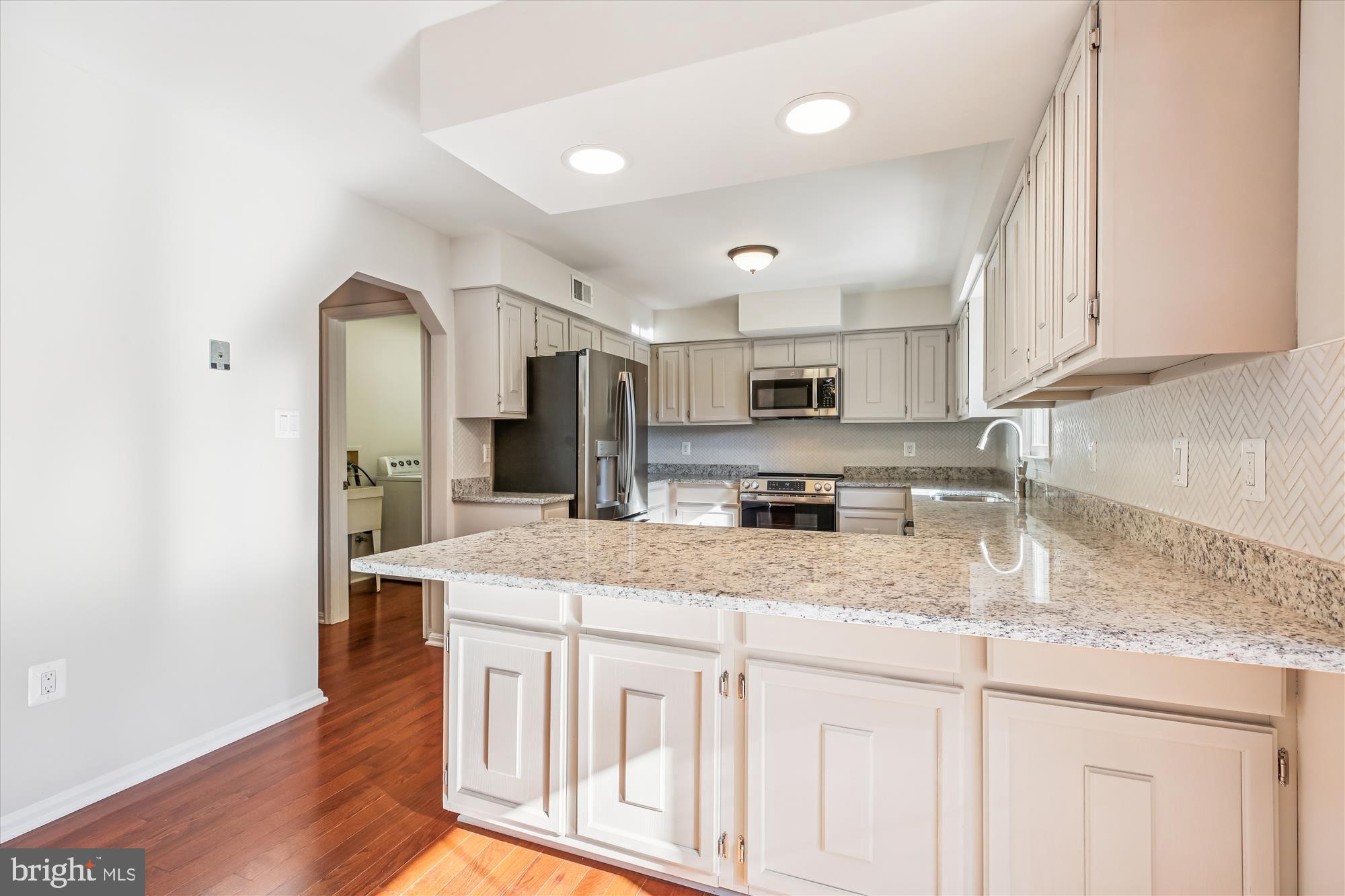17 Locustwood Court Silver Spring, MD 20905 - Photo 21 of 72 a kitchen with stainless steel appliances granite countertop a sink stove and refrigerator