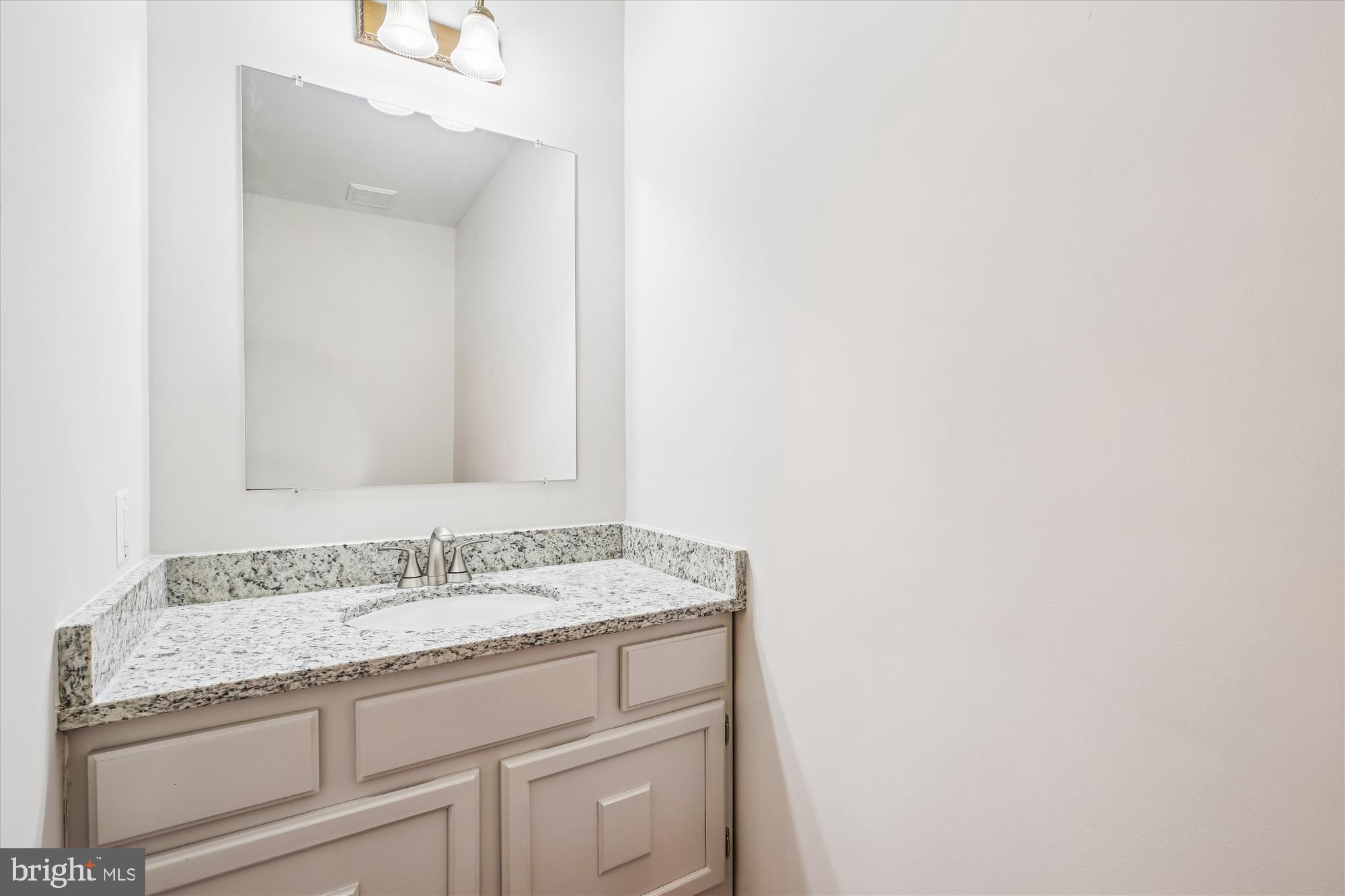 17 Locustwood Court Silver Spring, MD 20905 - Photo 28 of 72 a bathroom with a granite countertop sink and a mirror